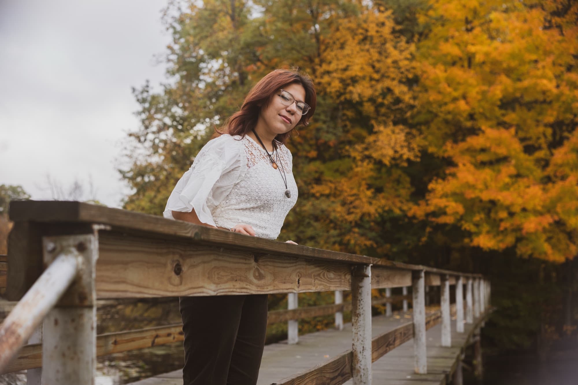 Senior portrait on an autumn bridge